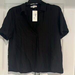 Black short sleeved blouse with tags.